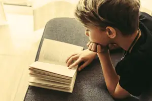 middle school reader on a couch