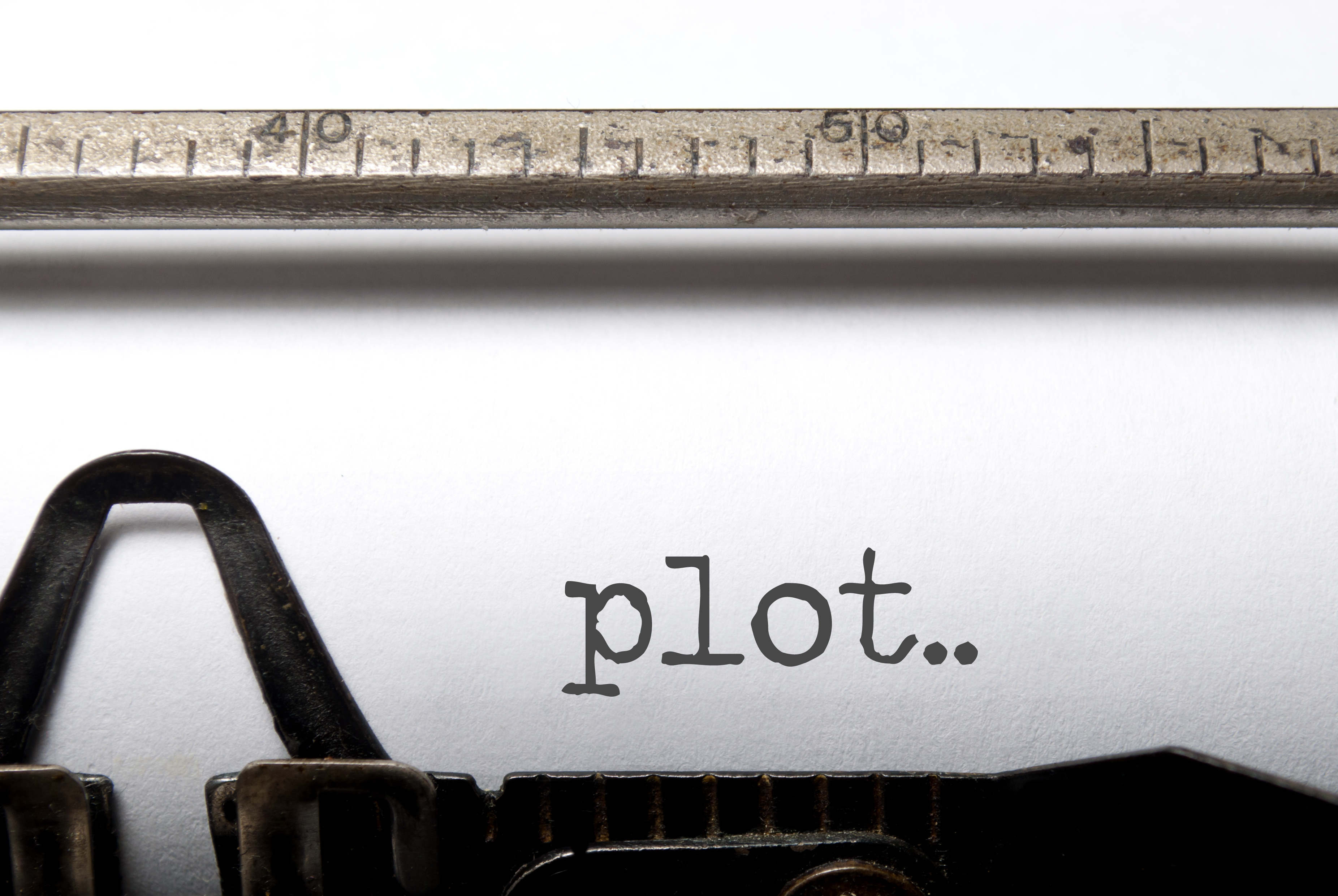 the word plot typed on vintage typewriter in traditional font used as a header on a blog about different plot diagrams and lines