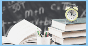 clock sitting on top of a stack of books with pencil cup and open book to the left in front of blackboard with letters in math problems used as blog banner top for scheduling interventions