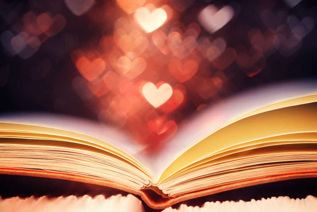 Open book against heart shaped floating lights for blog heading o celebrating the love of books all year